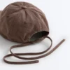 Cappellino effetto lavato in 100% cotone con laccio