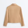 Giacca con peplo effetto neoprene e bordi a costine