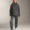 Giacca oversize in finta pelle di montone con cappuccio foderato in pelliccia sintetica Giacca oversize in finta pelle di montone con cappuccio foderato in pelliccia sintetica