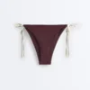 Slip bikini a copertura media con lacci Slip bikini a copertura media con lacci