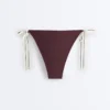 Slip bikini a copertura media con lacci Slip bikini a copertura media con lacci