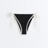 Slip bikini a copertura media con lacci e bordi a contrasto