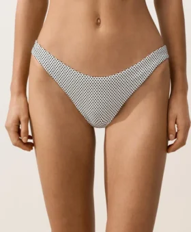 Slip bikini a copertura media con taglio a U in jacquard a pois