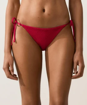 Slip bikini a copertura media con tessuto a nido d’ape e lacci