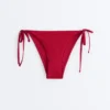 Slip bikini a copertura media con tessuto a nido d’ape e lacci Slip bikini a copertura media con tessuto a nido d’ape e lacci