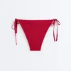 Slip bikini a copertura media con tessuto a nido d’ape e lacci Slip bikini a copertura media con tessuto a nido d’ape e lacci