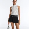 T-shirt senza maniche a righe con mezza zip T-shirt senza maniche a righe con mezza zip